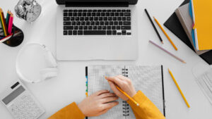 close-up-hand-writing-on-notebook-top-view-300x169 اهم الكورسات المجانية من منصة يوديمى